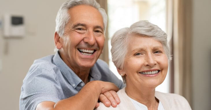 Happy senior couple showing their nice teeth in their smiles.