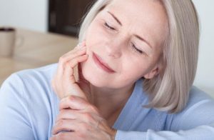 A middle-aged woman with dental pain caused by periodontal disease.