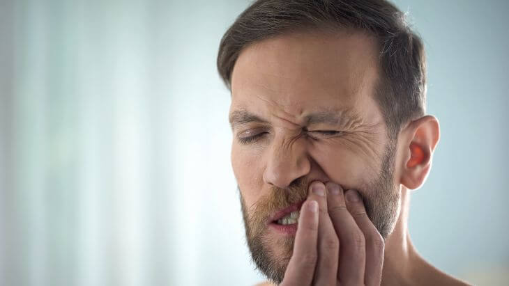 A man with severe dental pain.