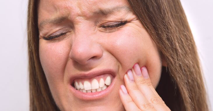 A woman with dental pain caused by gum disease.
