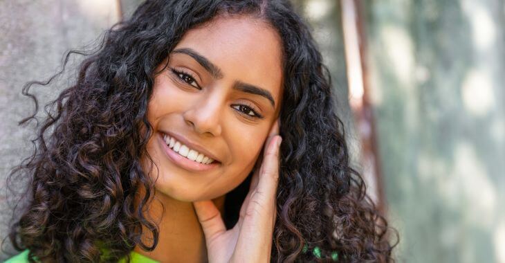 Happy young woman showing perfect teeth in her smile.