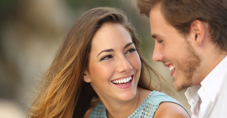 Happy young couple with perfect smiles.