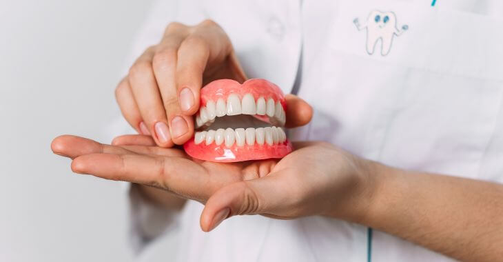A dentists presenting a set of dentures.