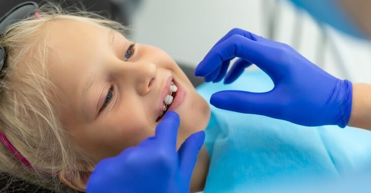Little girl with teeth braces during orthodontic appointment.