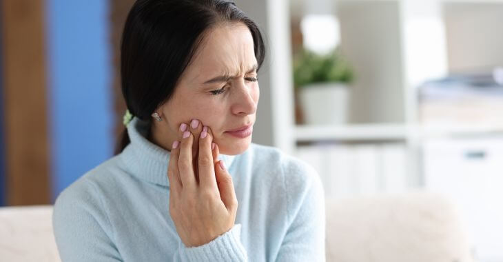 Woman suffering from dental pain