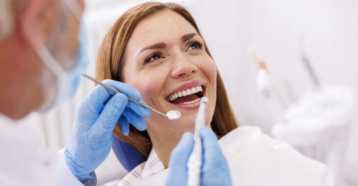 Woman during a dental checkup and cleaning appointment.