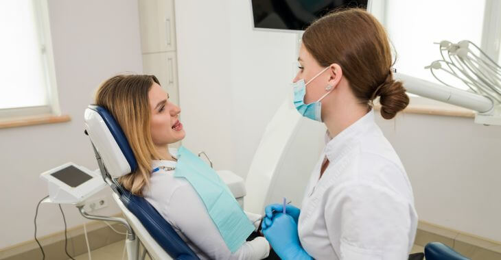 A dentist consulting a woman patient.