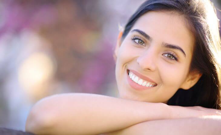 Young woman showing beautiful white teeth in her smile 