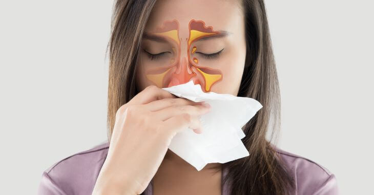 Woman with sinus infection cleaning her nose.