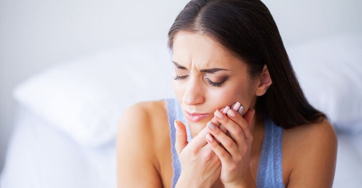 Woman with dental pain after tooth filling procedure